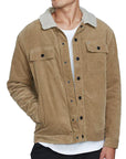 The front view of a man wearing a khaki button up corduroy jacket with two chest pockets. His right hand is in the right front pocket above the waist.