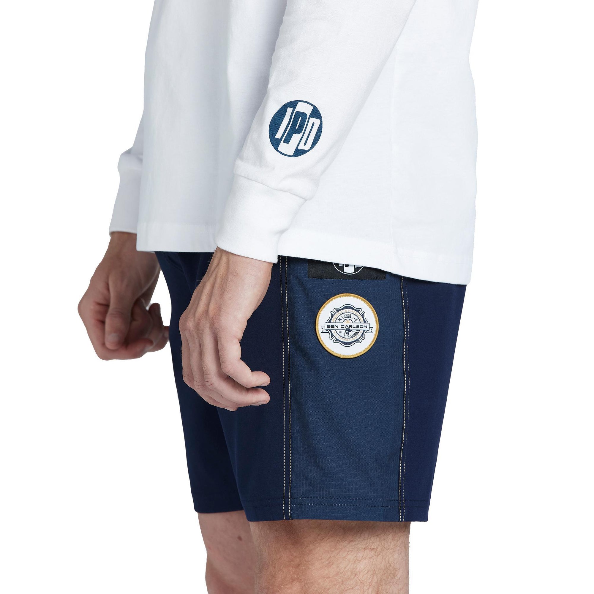 side view of circular ipd logo on wrist of white mens ben carlson long sleeve tree 