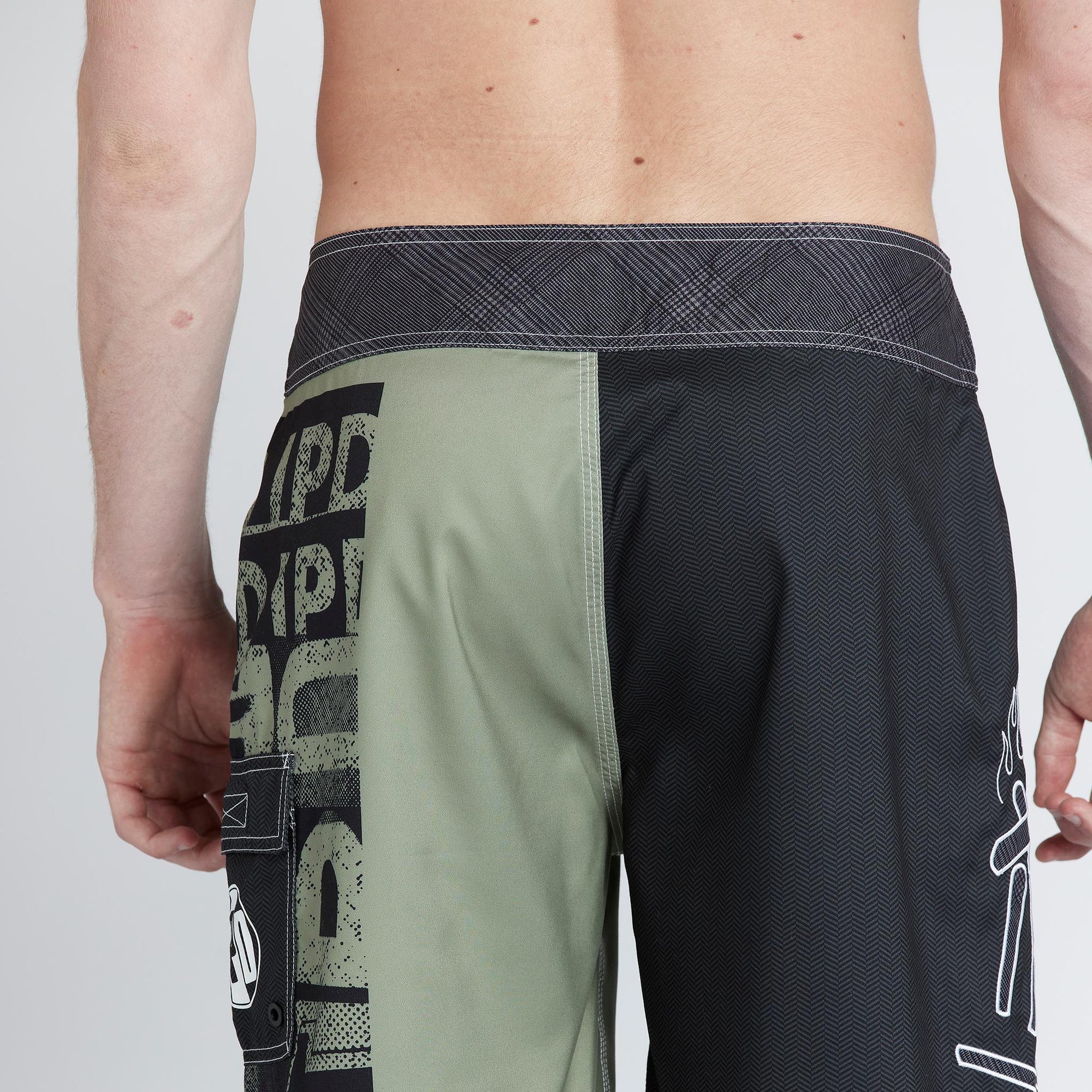 model wearing mens faceplant y2k fit 22" boardshort showing rear view with partial of left leg graphoc showing to back and side pocket