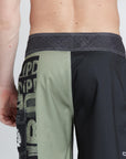 model wearing mens faceplant y2k fit 22" boardshort showing rear view with partial of left leg graphoc showing to back and side pocket
