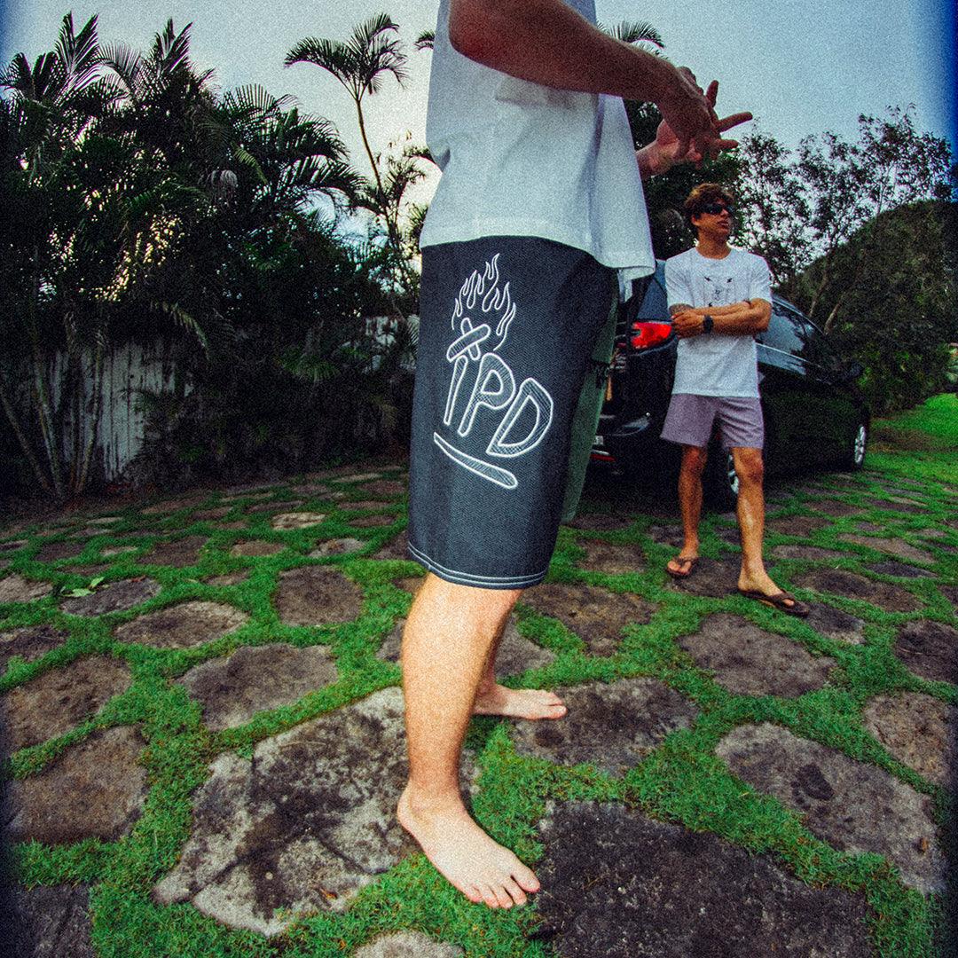 black - right side view of mens faceplant y2k fit 22" boardshort in black showing large IPD graphic on right side thigh 