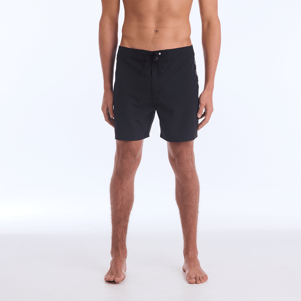 The B100 Chase boardshort features a 16” length and solid black coloring with a black and white striped side taping. It also has a waistband tie, side zipper pocket, and a black IPD logo patch halfway up the left leg taping.