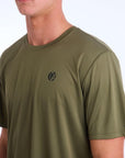 Front side view of an olive green polyester water resistant short sleeve Low Key Surf Shirt with a small I P D logo over the heart.