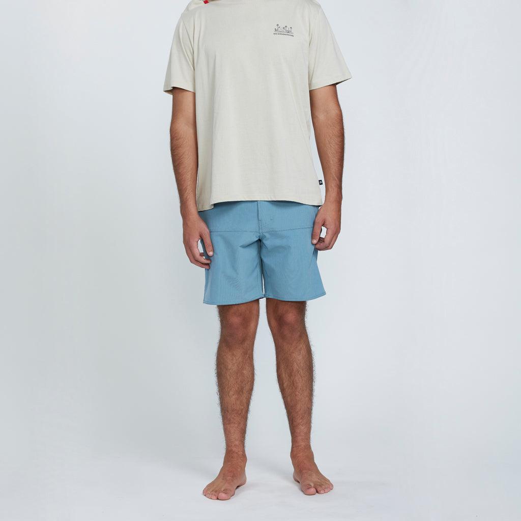 The front view of a man wearing blue shorts with two side pockets.