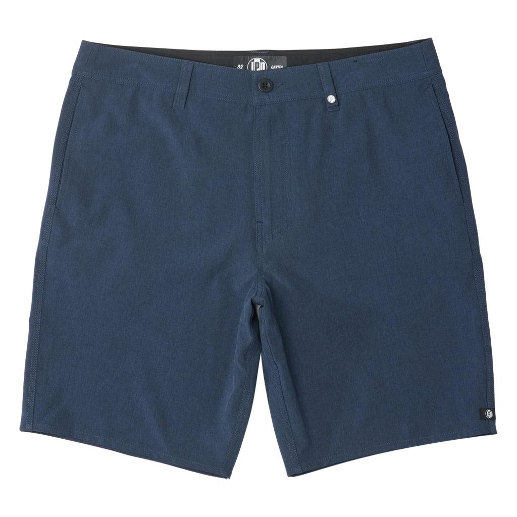 The Carter Hybrid features a 19” length in a classic walkshort silhouette in a waterproof fabric. The base color of the short is a heathered navy. The short also features belt loops, a zipper and button closure, two side pockets and two back pockets, and the signature smaller IPD flag label on the lower left leg.