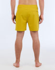 The B100 Chase boardshort features a 16” length and solid yellow coloring with a black and white striped side taping. It also has a waistband tie, side zipper pocket, and a black IPD logo patch halfway up the left leg taping. 