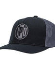 side view:A structured trucker hat with dark grey mesh on the back and a cotton twill black front. In the middle of the front is an embroidered IPD black and dark grey patch logo. This hat has a curved brim and adjustable snap back.