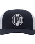 A structured trucker hat with white mesh on the back and a cotton twill white front. In the middle of the front is an embroidered IPD black and white patch logo. This hat has a curved brim and adjustable snap back. 