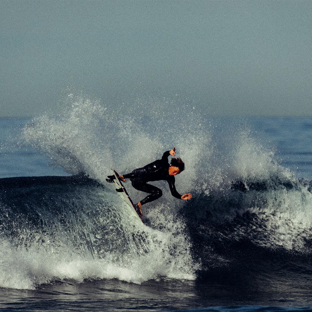 Surfer catches wave in mens 3M front chest zip full wetsuit 